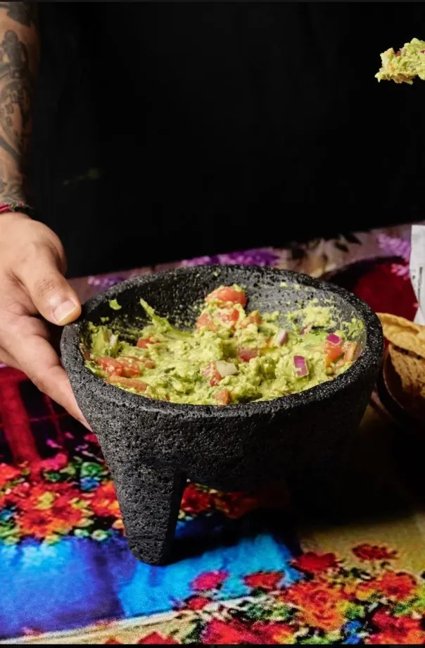 Fresh guacamole in traditional molcajete
